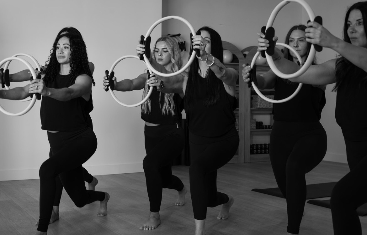 The Mat Pilates Ring work group class holding pose