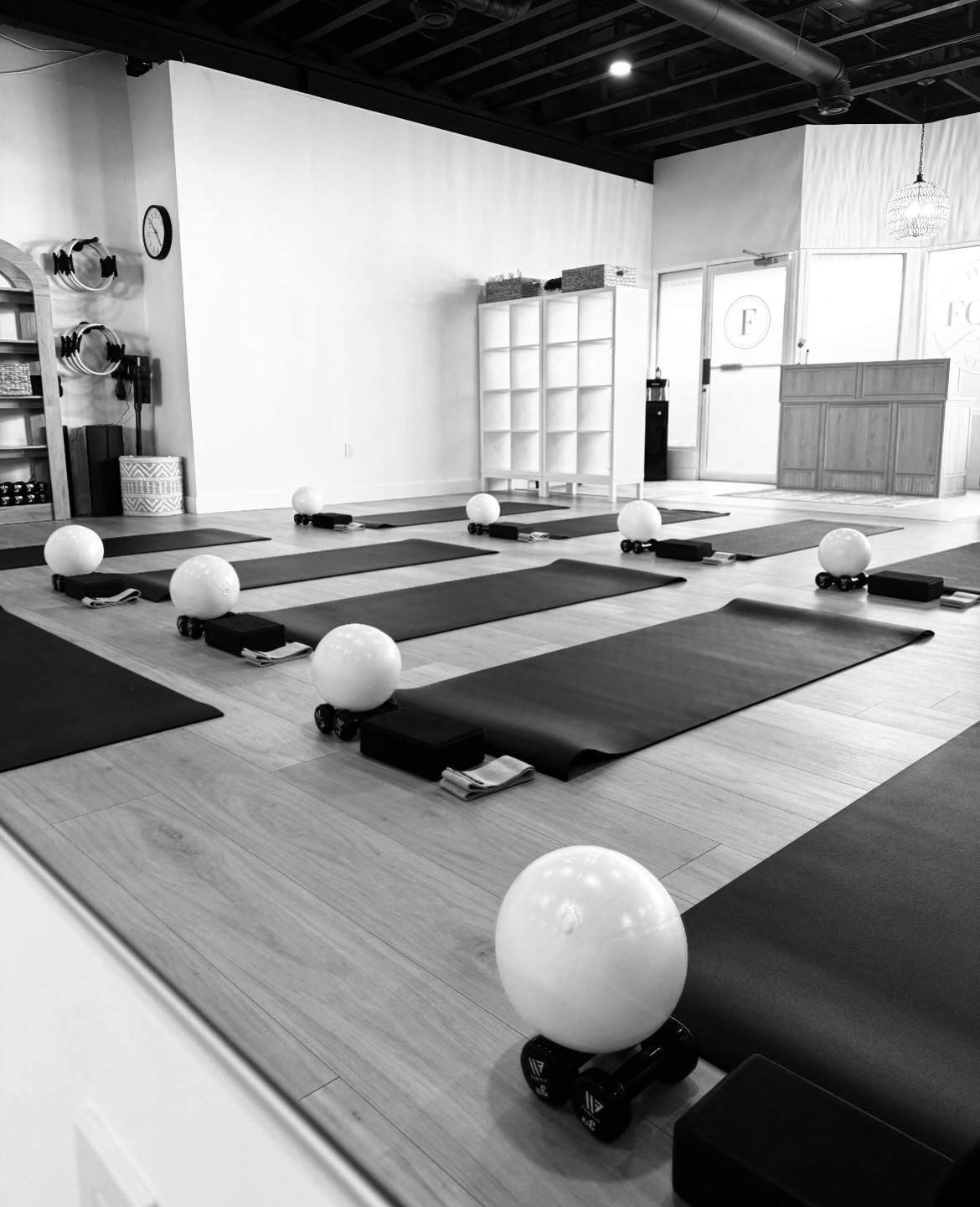 Pilates mats class set up with balls and bands